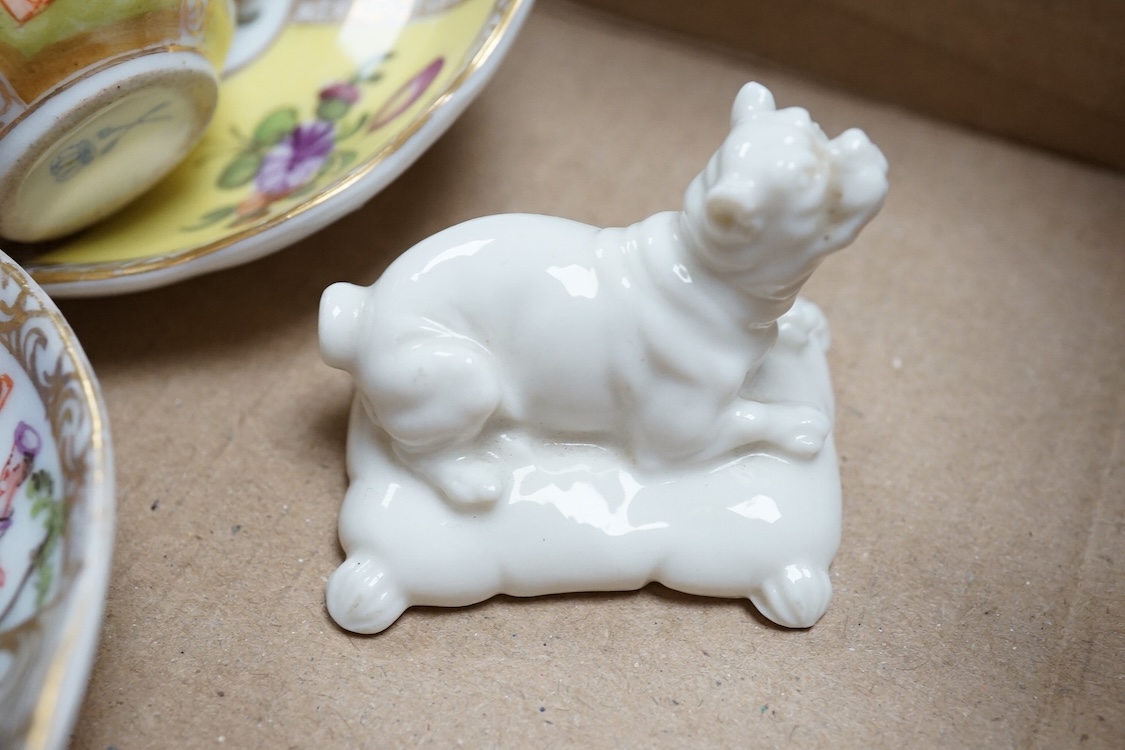 A group of 19th/20th century German porcelain, comprising a Nymphenburg pug, seven Dresden miniature cups and saucers and a Meissen bottle, largest 13cm high